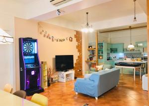 a living room with a blue couch and a video game at Cathy French House in Dongshan