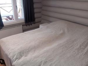 a white bed in a room with a window at Holiday Home Vahtamantie 8 b by Interhome in Saariselka