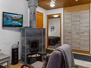 een woonkamer met een open haard en een flatscreen-tv bij Holiday Home Alppitalo sinitähti 9 apt 1 by Interhome in Tahkovuori