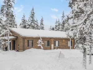 a log cabin in the woods in the snow at Holiday Home Pehtoori b by Interhome in Saariselka