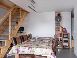 a dining room with a table with chairs and a staircase at Apartment L'Orée du Parc by Interhome in Saint-Gervais-les-Bains