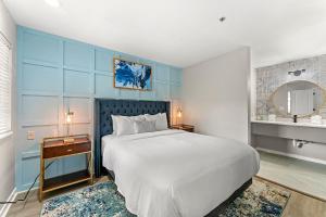 una camera da letto con un grande letto bianco e uno specchio di The 505 Collection Buckhead ad Atlanta