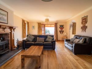 a living room with a couch and a coffee table at Holiday Home Ceilidhtail Cottage by Interhome in Drumnadrochit +68 photos
