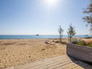 a view of a beach with a boat in the water at Apartment Les Jardins de la Nartelle Beach by Interhome in Sainte-Maxime