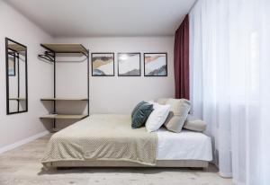 a bedroom with a bed with two pillows on it at Апартаменти MYFREEDOM поруч із метро Харківська in Kyiv