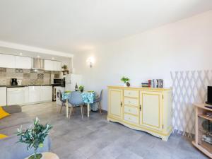 a living room with a kitchen and a dining room at Apartment Les Hauts des Issambres-7 by Interhome in La Garonnette-Plage