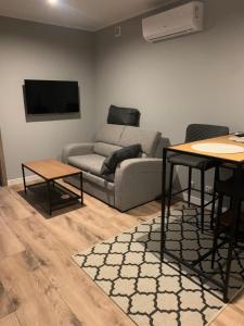 a living room with a couch and two tables at "B" Domki na wodzie Barczewko 2 z 4 domków in Barczewko