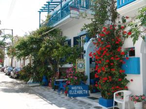 a street with flowers in front of a building at Hotel Elizabeth in Naxos Chora