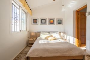 a bedroom with a bed and a window at Alto Rey Torrox Beach in Torrox Costa
