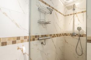 a shower with a glass door in a bathroom at Alto Rey Torrox Beach in Torrox Costa +18 photos