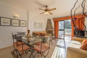 a living room with a glass table and chairs at Alto Rey Torrox Beach in Torrox Costa