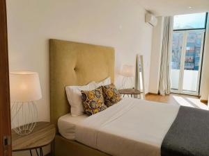 a bedroom with a bed with pillows and a window at Asgard Oporto Downtown Apartments in Porto