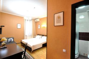 a hotel room with a bed and a bathroom at Flamingo Hotel in Tbilisi City +43 photos