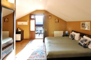 a bedroom with a bed and a room with a table at Flamingo Hotel in Tbilisi City