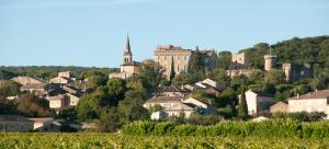 a town on a hill with a castle at La Maison Ocre in Rochegude-Drome