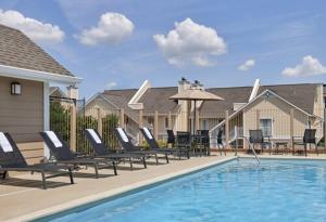 a swimming pool with lounge chairs and a swimming pool at Sonesta ES Suites Cincinnati - Sharonville West in Sharonville