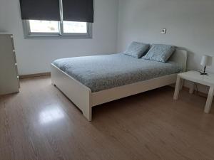 a bedroom with a bed with two pillows on it at Modern Suite, XL balcony, parking in Nicosia