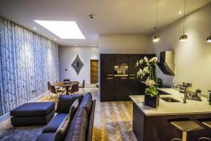 a living room with a couch and a table at The Halston Carlisle in Carlisle