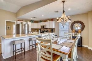 a kitchen and dining room with a table and chairs at Barefoot Bungalow in Galveston
