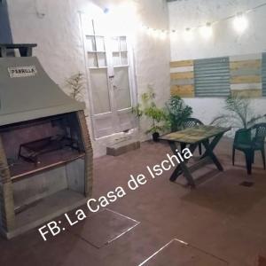 a living room with a fireplace and a table at La Casa de Ischia in Mar del Plata