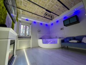a large living room with a tub and a couch at Old Town Suite in Guardiagrele