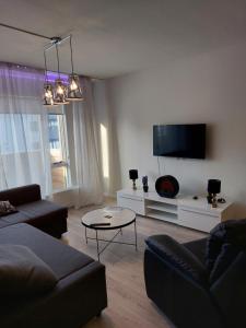 a living room with a couch and a flat screen tv at Apartment near the airport in Ytri-Njarðvík