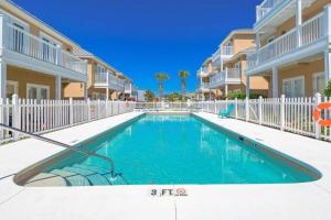 a swimming pool in front of some apartment buildings at * Sugar Sands * Steps to Beach * Pool * Balconies * in Panama City Beach