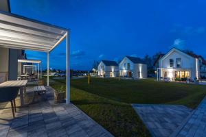 a view of a house with a patio at night at Zatoka Mew in Władysławowo