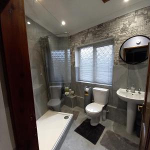 a bathroom with a toilet and a sink at Middlethorpe Apartment in York