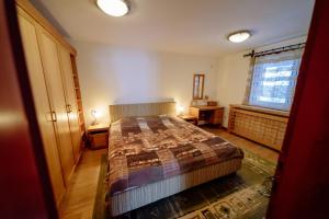 a bedroom with a bed and a window at Vila LALUKO in Zlatibor