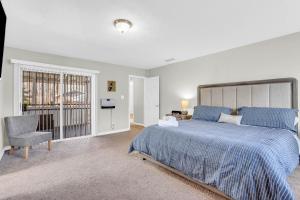 a bedroom with a large bed and a chair at Cornell Comfort in Atlanta