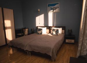 a bedroom with a large bed with two pillows at Flamingo Hotel in Tbilisi City