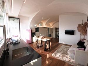cocina y sala de estar con mesa y sofá en Gioiello sul lago d'Iseo, en Sale Marasino