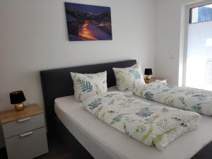 a bed with two pillows on top of it at Traumwohnung Füssen 22 in Füssen