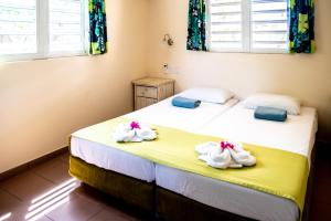 zwei Betten in einem Zimmer mit Handtüchern darauf in der Unterkunft Hamlet Oasis Resort in Kralendijk + 33 Fotos