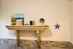 a wooden table with a mirror on a wall at Casa Salvia in Garda