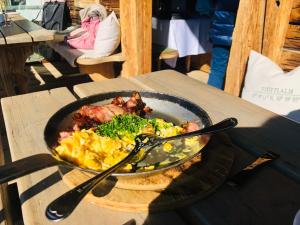 a plate of food with meat and vegetables on a table at Haus Schmid in Tobadill +42 photos