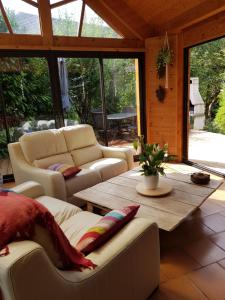 a living room with couches and a wooden table at La Grange in Le Noyer