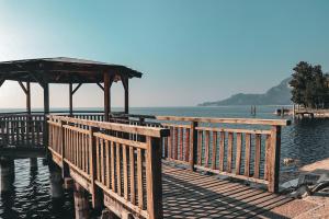 a wooden dock with a gazebo on the water at Casa Salvia in Garda