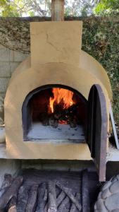 a brick oven with a fire inside of it at Sendero extremo in Jalcomulco