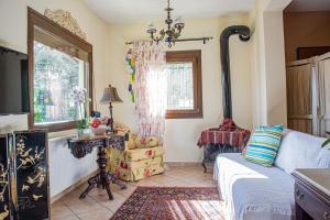 a living room with a couch and a window at Sofia's House in Paleo Tsifliki