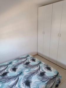 a room with a bed in the corner of a room at One bedroom private apartment - quiet near a park in Beer Sheva