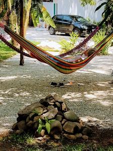 a hammock in a yard with a pile of rocks at Sendero extremo in Jalcomulco