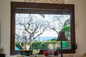 a large window with a view of the ocean at Sofia's House in Paleo Tsifliki
