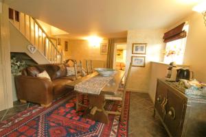 a living room with a couch and a table at Dannah Farm Country House in Shottle