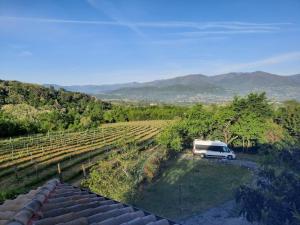a white van parked in a field with mountains in the background at Azienda del Lupo - Caravan mit Ambiente in Bagnone