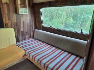 a seat in the back of a trailer with a window at Azienda del Lupo - Caravan mit Ambiente in Bagnone