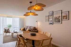 a living room with a table and a couch at Island Retreat Apt (city center) in Ponta Delgada