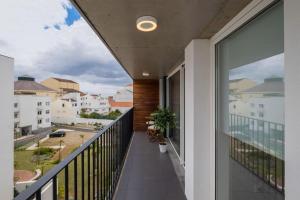 a balcony with a view of a street and buildings at Island Retreat Apt (city center) in Ponta Delgada