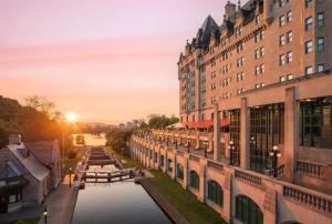 a view of a canal between buildings at sunset at Fairmont Chateau Laurier Gold Experience in Ottawa